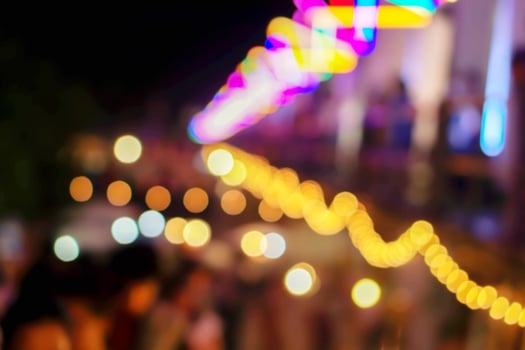 Blurred and bokeh of festival and food booths refection lighting in night time. photo