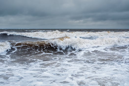 Stormy winter waves on the White Sea. Dramatic seascape. photo