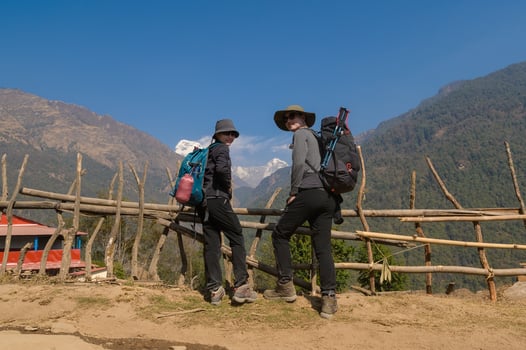 A young couple travellers trekking in Poon Hill view point in Ghorepani, Nepal photo