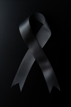 Black mourning ribbon with a dark background. photo