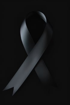 Black mourning ribbon with a dark background. photo