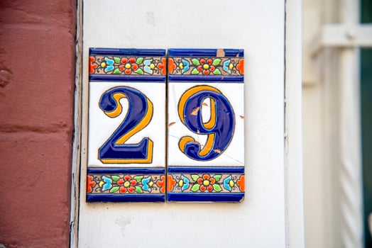 An old porcelain sign with the number 29. photo