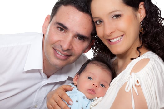 Young parents with their one month baby girl isolated on white background photo