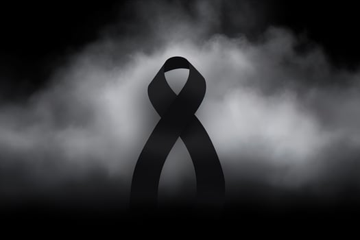 Black mourning ribbon with a dark smoke background. photo