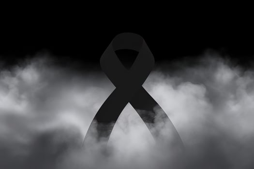 Black mourning ribbon with a dark smoke background. photo