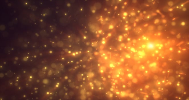 Abstract yellow orange energy particles and dots glowing flying sparks festive with bokeh effect and blur background photo