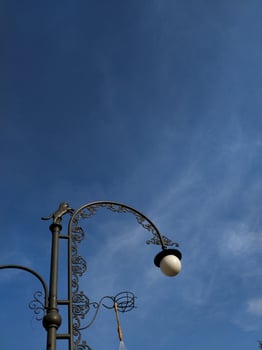 Beautiful vintage style lamp post artwork with blue sky. photo