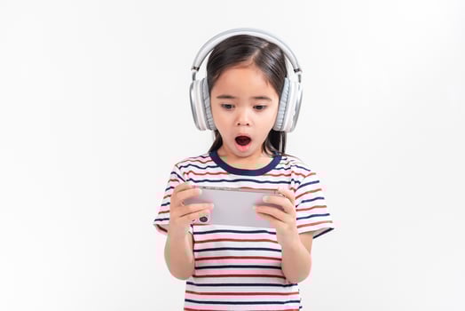 Little girl play phone mobile. Isolated on white background photo