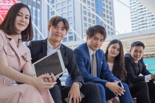 Group of asian business people smiling and looking at camera photo