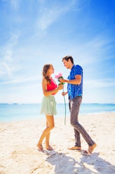 man making a proposal to a woman on a beach photo