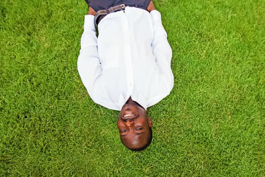black man lying down on a grass photo