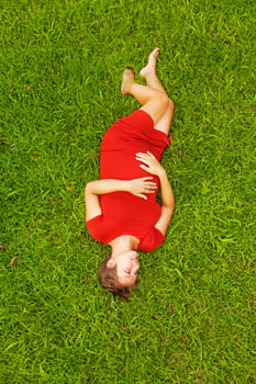 Pregnant woman lying on the grass photo