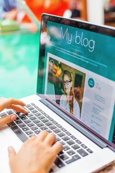 a person is typing on a laptop with the word my blog on it photo