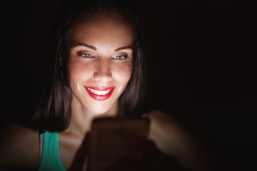 woman using smart phone in darkness photo