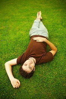 Man laying on the grass photo