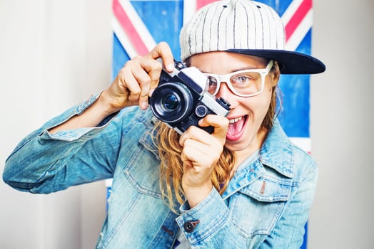 amateur style portrait of cute young woman with retro camera instagram filter applied photo