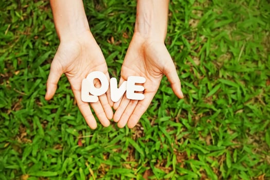 amateur style photo of word love in two hands instagram filter is applied