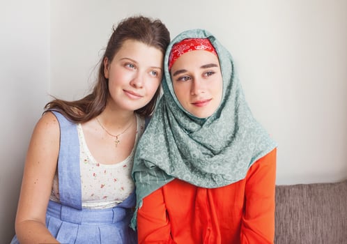 friendship of the religions concept muslim and christian girl together photo
