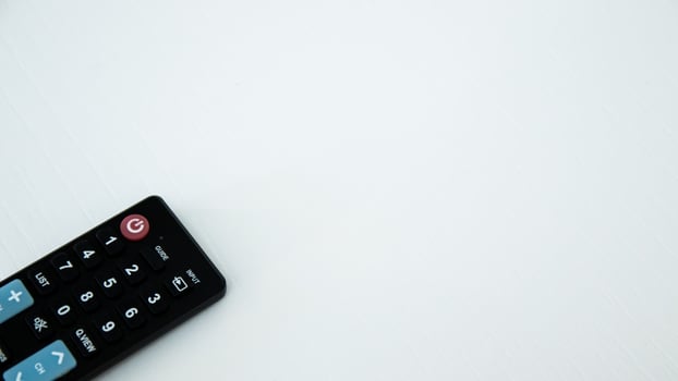 TV remote control on white background. Selective focus and shallow depth of field. photo