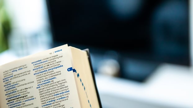English dictionary open with the background of a living room photo