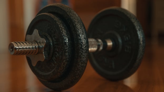 Dumbbells on a wooden floor. Close-up. photo