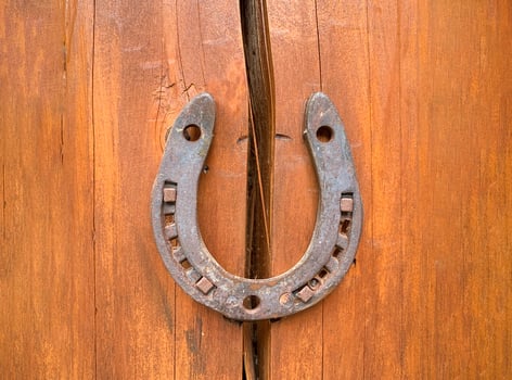 Horseshoe on a wooden crack. The concept of good luck and safety. Protect from destruction, failures and misfortunes. Superstitions and beliefs. Problem solution. Strengthening and security. Insurance photo