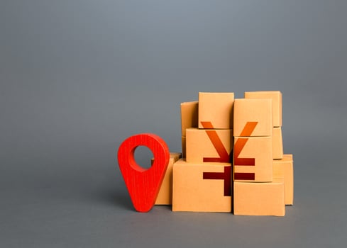 Boxes with chinese yuan or japanese yen symbol and red location pin. Import export. Domestic manufacturer. Supply distribution of goods. Transportation delivering logistics, management. Trade in goods photo