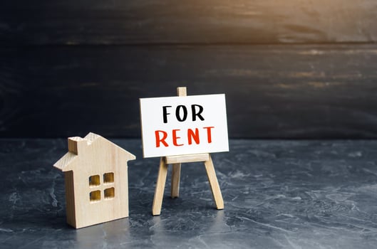 House figurine and sign for rent. Real estate realtor services. Legal procedure for concluding a contract. Investment in rental business. Purchase of housing for rent. Profit and payback forecasting. photo