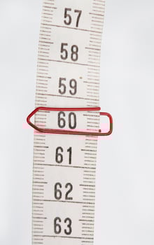 Paper clip on number sixty at measuring band. photo