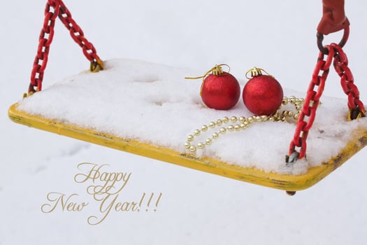 Christmas balls in the snow on a swing seat photo