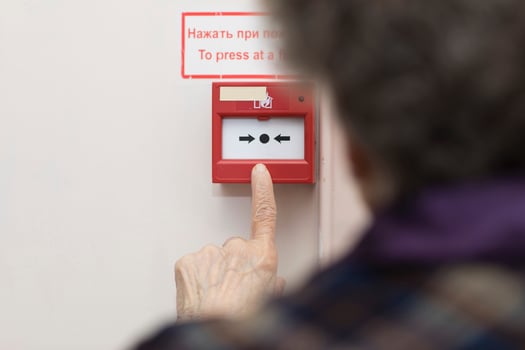 Senior woman wants to press an emergency button photo