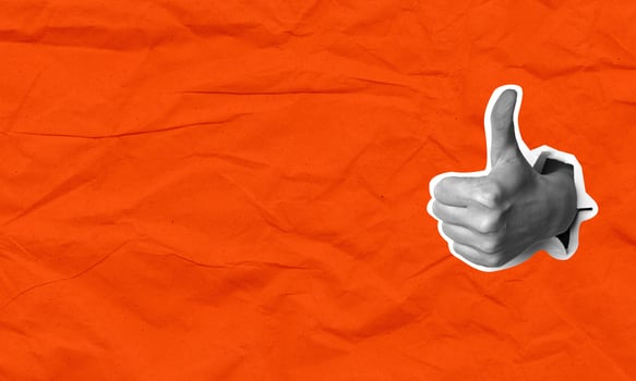 Female hand with thumbs up gesture on a red background, art collage. Positive hand sign. photo