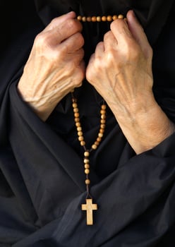An old woman  is praying photo