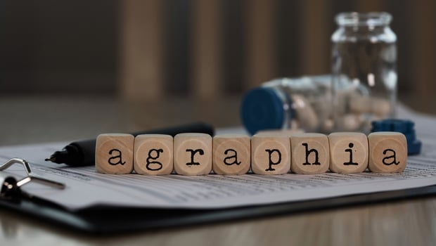 Word AGRAPHIA composed of wooden dices. photo