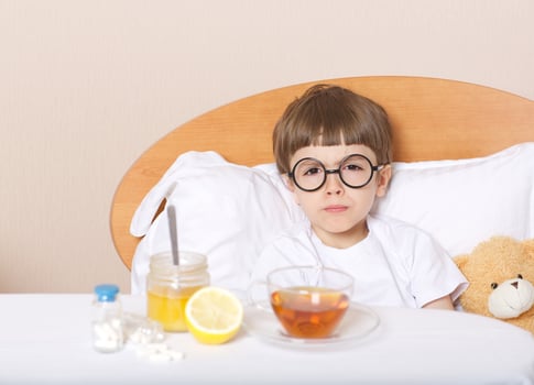 Sick boy in his bed photo