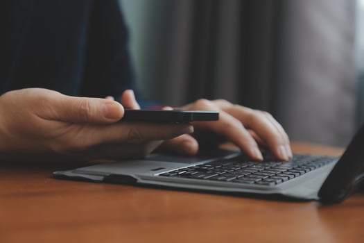 Asian Businesswoman Using laptop computer and working at office with calculator document on desk, doing planning analyzing the financial report, business plan investment, finance analysis concept. photo