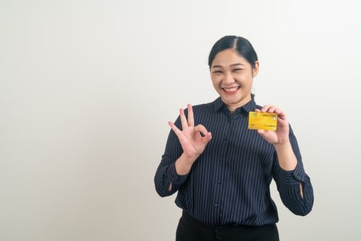 Asian woman holding credit card with white background photo