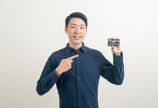 young Asian man holding credit card photo