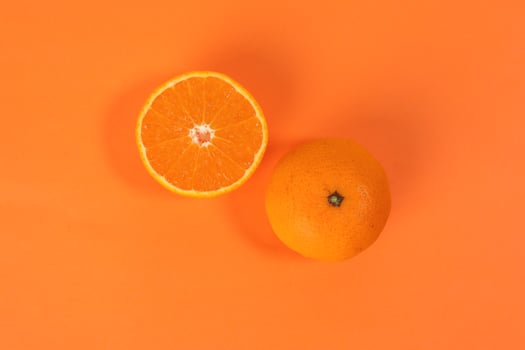 Mandarin Orange Fruit slice half on orange background photo