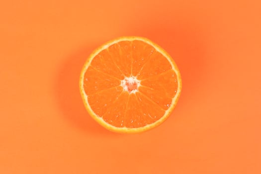 Mandarin Orange Fruit slice half on orange background photo