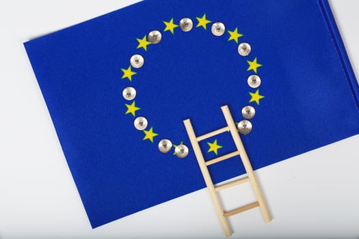 Ladder and pins on an European flag. Closeup photo