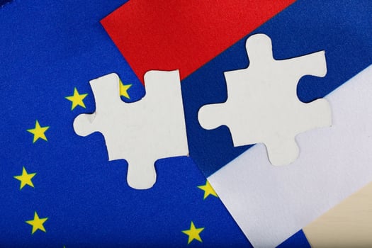 Two pieces of puzzle on European and Russian flag. Background photo