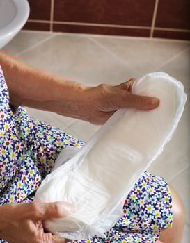 Senior woman wants to apply incontinence liners in her hands photo