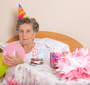 Old woman celebrates her birthday photo