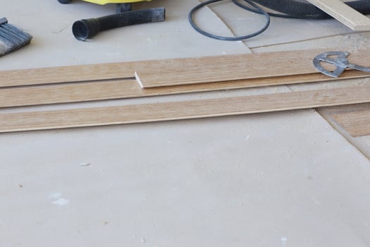 Pieces of wooden plinth placed on a floor. photo