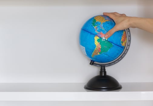 Colorful paper globe on a book shelf. photo