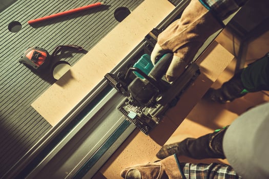 Top View of Power Saw Cutting a Wooden Plank photo