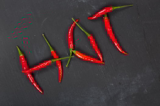 Fresh hot chili pepper on a wooden surface. photo