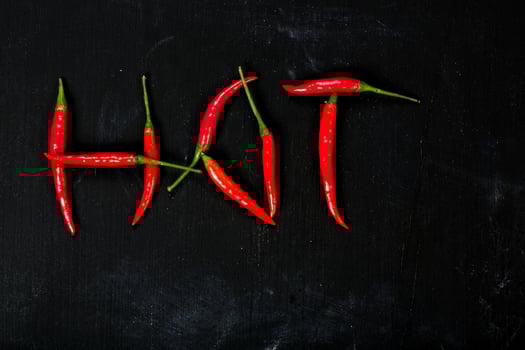 Fresh hot chili pepper on a wooden surface. photo