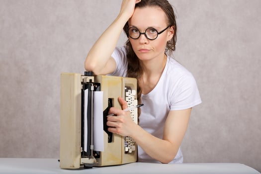 Young lady  with typing machine. Closeup photo